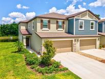 Beautiful two-story townhome with attached two-car garage and landscaped front yard at 17729 Nectar Flume Dr, Land O Lakes, FL 34638