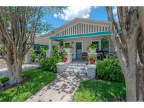 Charming bungalow featuring well-maintained landscaping and a covered front porch with a pop of turquoise accents at 204 E North St, Tampa, FL 33604