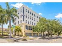 Attractive condominium building, Palladium Flats, featuring clean lines, neutral colors, and beautiful trees at 205 5Th N Ave # 501, St Petersburg, FL 33701