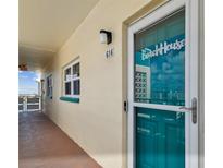Condo front door with modern door hardware, unit number, and view of city skyline at 2960 59Th S St # 614, Gulfport, FL 33707