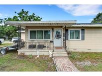 Charming single-story home with a covered front porch and well-maintained landscaping, creating a welcoming curb appeal at 3008 Jackson N St, St Petersburg, FL 33704
