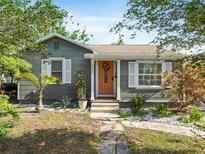 Charming single-story home with gray siding, white shutters, and a vibrant coral front door at 3305 10Th N Ave, St Petersburg, FL 33713