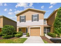 Charming townhome with a one car garage, manicured landscaping, and neutral color palette at 4528 Winding River Way, Land O Lakes, FL 34639