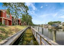 Scenic waterfront view with condos, a boardwalk, and serene canal at 5582 Baywater Dr, Tampa, FL 33615