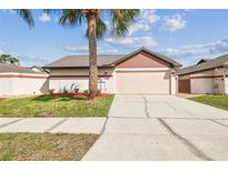 Charming single-story home with a well-maintained lawn, complemented by a freshly sealed driveway at 7004 Westminster St, Tampa, FL 33635