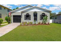 Charming single-story home featuring a well-maintained front yard and classic architectural details at 7208 S Juanita St, Tampa, FL 33616