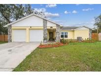 Charming single Gathering home with a two car garage and inviting stone facade in a well manicured community at 8001 Pagoda Dr, Spring Hill, FL 34606