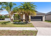 Charming single-Gathering home with well-manicured landscaping and a brick driveway at 9931 Victory Gallop Loop, Ruskin, FL 33573