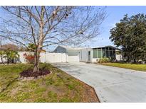 Charming one-story home showcasing a well-manicured front yard and driveway, complete with mature trees at 1701 66Th N Ave, St Petersburg, FL 33702
