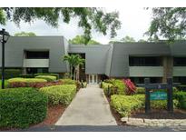 Well maintained Condo building with lush landscaping and mature trees at 36750 Us 19 N # 24-211, Palm Harbor, FL 34684
