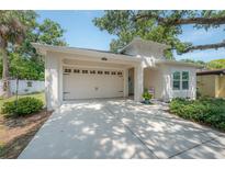 Bright exterior view of the home highlighting the attached garage and inviting front entrance at 3906 N Lynn Ave, Tampa, FL 33603