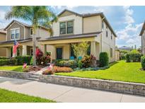 Charming two-story home featuring a welcoming front porch and beautifully landscaped front yard at 4264 Bexley Village Dr, Land O Lakes, FL 34638
