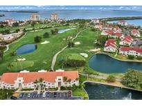 Beautiful aerial view of community featuring a golf course, ponds, and manicured landscaping with waterfront views at 6131 Bahia Del Mar Blvd # 241, St Petersburg, FL 33715
