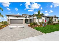 Beautiful single-Gathering home with a lush lawn, large driveway, and a two-car garage at 8913 Bernini Pl, Sarasota, FL 34240