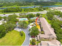 A top-down view showing community amenities and property location near the river and highway at 3044 Red Oak Ct # 204, Palm Harbor, FL 34684