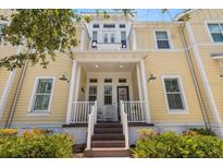 Charming yellow townhome with inviting front porch and well-maintained landscaping at 340 Sapphire Lake Dr # 202, Bradenton, FL 34209