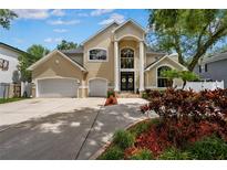 Stunning two-story home featuring a well-manicured front yard and grand entrance with decorative wreaths at 4515 W Leona St, Tampa, FL 33629