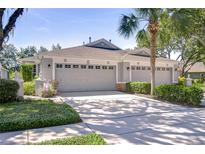 Charming home with a three-car garage, well-manicured landscaping, and a spacious driveway at 6030 Sandhill Ridge Dr, Lithia, FL 33547