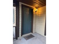 Inviting front entrance with a welcoming doormat and charming exterior light fixture at 8105 Sheldon Shores Dr, Tampa, FL 33615