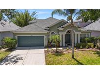 Charming single-Gathering home featuring a well-manicured lawn and a two-car garage with beautiful landscaping at 12443 Adventure Dr, Riverview, FL 33579