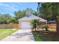 Charming home featuring a well-maintained lawn, and a driveway leading up to a two-car garage at 1344 S Michigan Ave, Clearwater, FL 33756