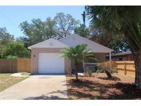 Charming single-story home featuring a one-car garage, well-maintained lawn, and tropical landscaping at 1344 S Michigan Ave, Clearwater, FL 33756