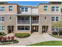 Charming townhouse with brick accents, dual balconies and well-maintained landscaping at 1543 W Cass St, Tampa, FL 33606