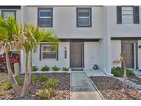 Charming townhouse entrance with decorative rock and mulch landscaping plus white painted brick facade at 2011 S Carolina Ave, Tampa, FL 33629