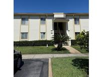 Inviting two-story condo building featuring well-maintained landscaping and a charming entrance at 210 Cypress Ct # 122, Oldsmar, FL 34677