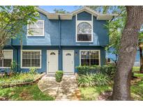Charming blue townhouse with well-maintained landscaping and inviting front entrance at 3343 Fox Hunt Dr, Palm Harbor, FL 34683