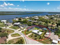 Waterfront property with lush landscaping and dock access to the beautiful canal with gulf access at 3420 Santa Clara Dr, Punta Gorda, FL 33983