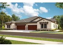 Charming single-story home featuring a two-car garage, neutral stucco, stone accents, and a well-manicured lawn at 35571 Stableton Ln, Zephyrhills, FL 33541