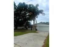 Charming single-story home with a well-manicured lawn and a two-car garage at 4824 Huntington Ne St, St Petersburg, FL 33703