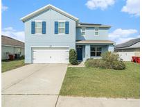 Inviting two-story home with a well-manicured lawn and two-car garage at 3509 San Moise St, Plant City, FL 33567
