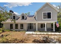 Charming two-story home with a well-manicured lawn and welcoming front porch at 11207 Donneymoor Dr, Riverview, FL 33569