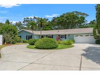 Charming single-story home featuring an attached garage and a circular driveway at 1240 Harbor Lake Dr, Largo, FL 33770