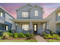 Charming two-story home with a welcoming front porch, landscaped garden and a brick walkway at 13614 Stevenson Ln, Odessa, FL 33556