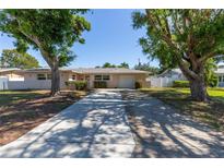 Charming single-story home with a long driveway and mature trees in a quiet neighborhood at 1400 63Rd S Ave, St Petersburg, FL 33705