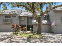 Charming two-story townhome with a well-maintained lawn and mature tree in a desirable neighborhood at 2033 Arbor Dr, Clearwater, FL 33760