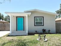 Charming single-story home boasts a striking turquoise door and freshly landscaped front yard at 3708 N 56Th St, Tampa, FL 33619