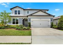 Charming two-story home featuring a two-car garage and well-maintained landscaping at 3952 Almond Brook Blvd, Land O Lakes, FL 34638