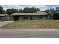 Charming single-story home with a well-maintained lawn and attached garage at 39772 Meadowood Loop, Zephyrhills, FL 33542