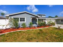 Charming single Gathering home featuring fresh landscaping, including red mulch and tropical plants at 6536 115Th Ln, Seminole, FL 33772