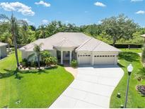 Charming single-story home boasting a well-manicured lawn, tile roof, and a spacious three-car garage at 6933 Cozumel Ct, Land O Lakes, FL 34637