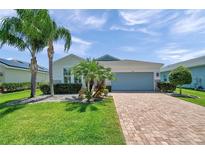 Charming home with well-manicured lawn, stone accents and brick paver driveway at 764 W Bayshore Dr, Tarpon Springs, FL 34689