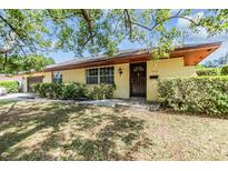 Charming single-story home featuring a well-manicured lawn and lush green shrubbery enhancing its curb appeal at 309 Kenmore Rd, Brandon, FL 33511