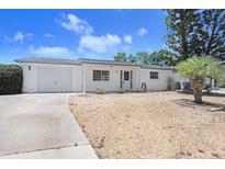 Charming single-story home featuring a one car garage, well-maintained landscaping, and a cozy front porch at 3247 Kimberly Oaks Dr, Holiday, FL 34691