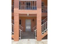 Building entrance featuring stairs, a doorway, and an upstairs balcony in an older building complex at 3514 Gulf # 2, St Petersburg, FL 33706