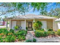 Charming single-story home with a well-maintained front yard, inviting entrance, and a cozy seating area on the porch at 4125 W Obispo St, Tampa, FL 33629