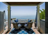 Outdoor patio showcasing a table and chairs, providing a relaxing space with an ocean view at 5042 Coquina Key Se Dr, St Petersburg, FL 33705